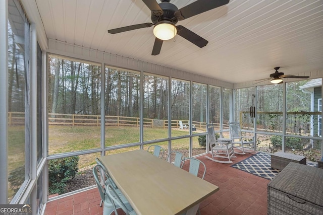 sunroom featuring plenty of natural light and a ceiling fan