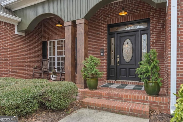 property entrance featuring brick siding