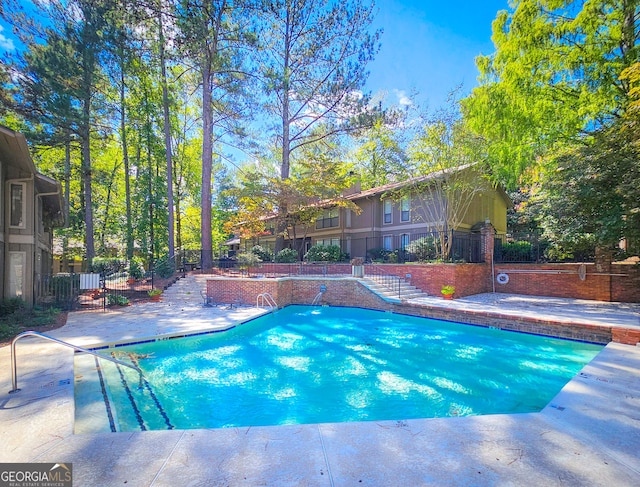 view of swimming pool with fence