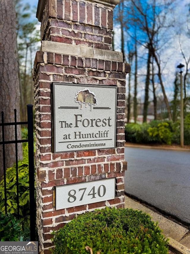 community sign featuring fence