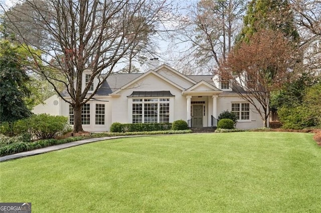 view of front of house with a front lawn and stucco siding