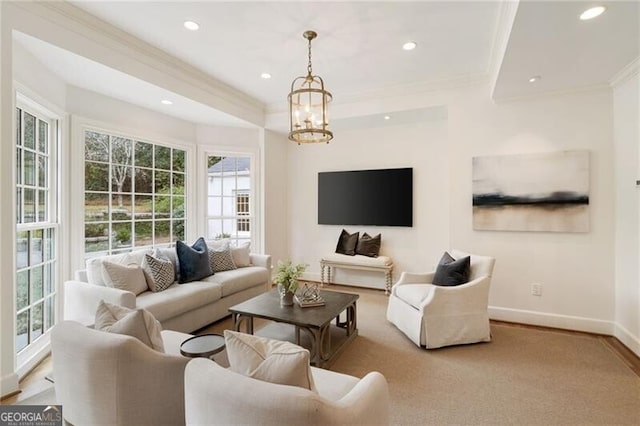 living room featuring recessed lighting, a chandelier, baseboards, and ornamental molding