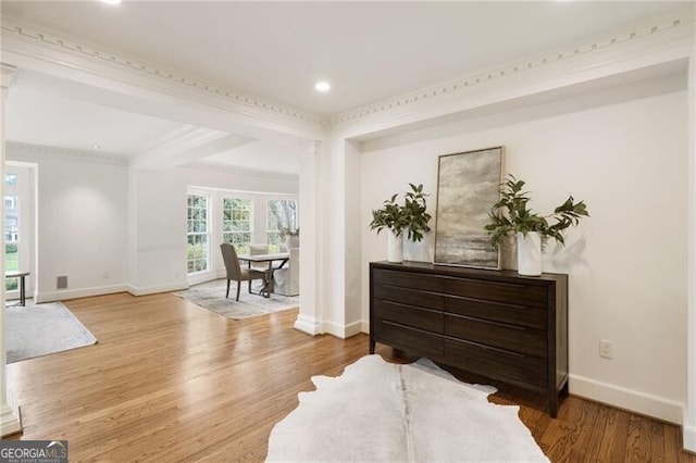 living area with ornate columns, recessed lighting, baseboards, and wood finished floors