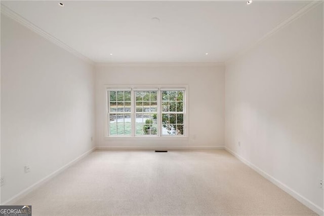 empty room with carpet, baseboards, and ornamental molding