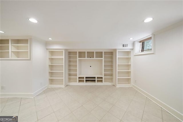 below grade area with visible vents, light tile patterned floors, recessed lighting, and baseboards