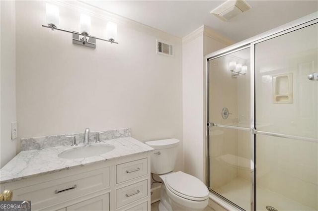 bathroom featuring visible vents, a shower stall, toilet, and vanity