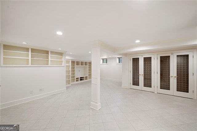 finished below grade area featuring recessed lighting, built in shelves, french doors, and baseboards