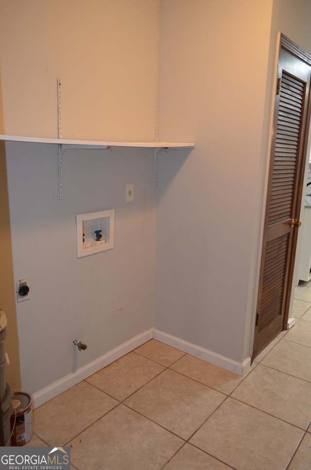 laundry room featuring gas dryer hookup, light tile patterned floors, baseboards, hookup for an electric dryer, and hookup for a washing machine