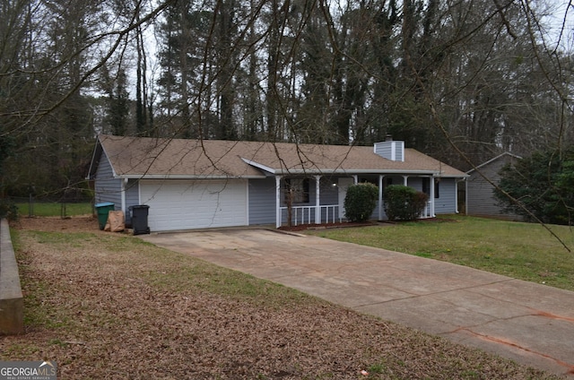 single story home with a porch, an attached garage, a chimney, concrete driveway, and a front lawn