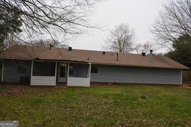 rear view of property with a lawn