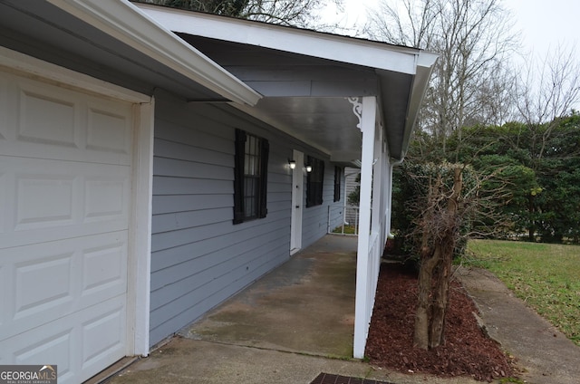 exterior space with covered porch and an attached garage