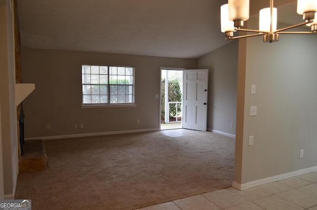 unfurnished living room with baseboards, light colored carpet, vaulted ceiling, light tile patterned floors, and an inviting chandelier