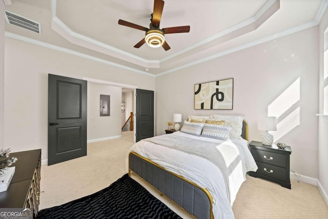 bedroom with baseboards, visible vents, carpet floors, a tray ceiling, and crown molding