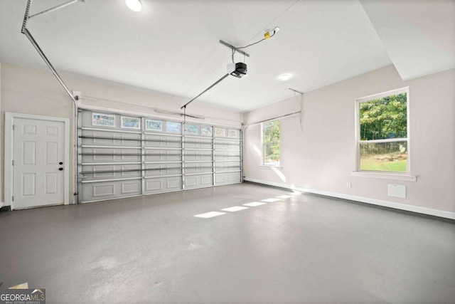 garage with a garage door opener and baseboards