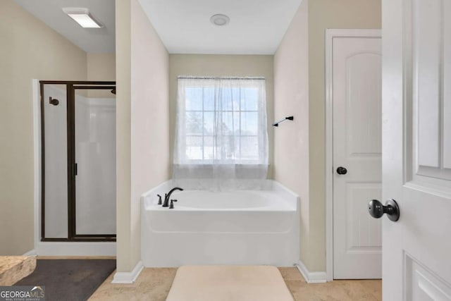 bathroom with a garden tub and a shower stall