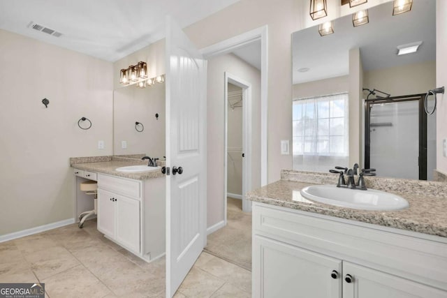 full bathroom with visible vents, a shower stall, two vanities, and a sink