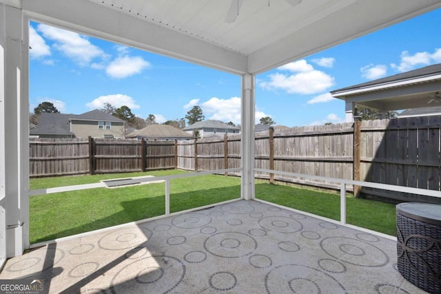 unfurnished sunroom with ceiling fan