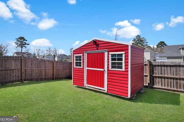 view of shed with a residential view and a fenced backyard