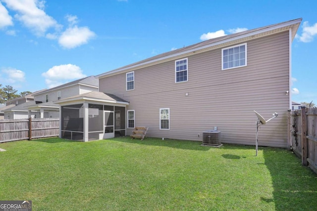 rear view of property with a fenced backyard, a lawn, central AC, and a sunroom