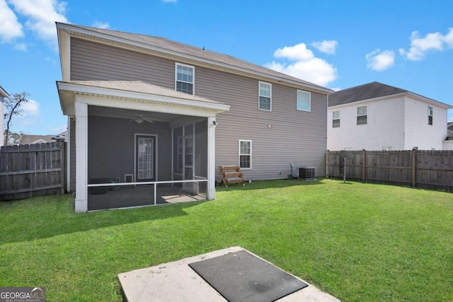 rear view of house featuring a lawn, cooling unit, a fenced backyard, and a sunroom