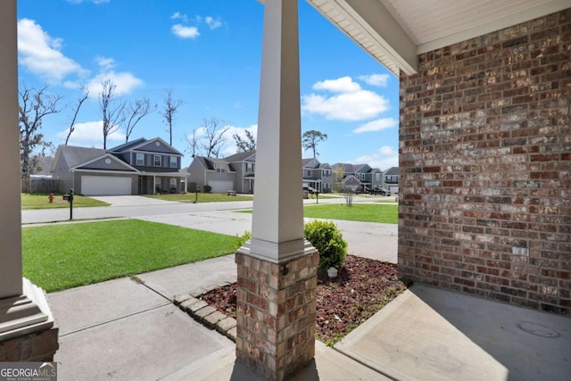 view of patio / terrace with a residential view and a porch