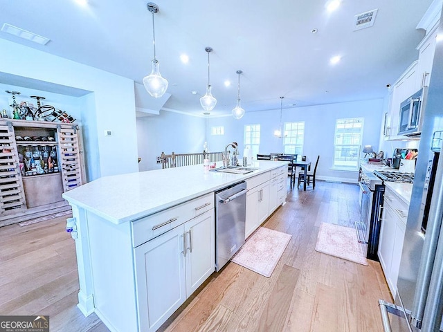 kitchen with light wood finished floors, visible vents, appliances with stainless steel finishes, and light countertops