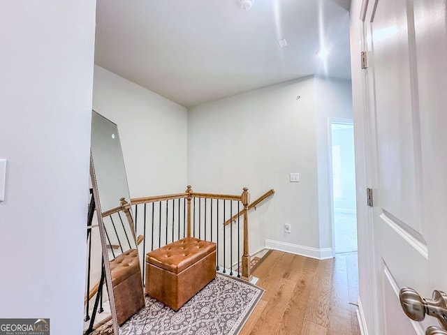 stairway featuring baseboards and wood finished floors