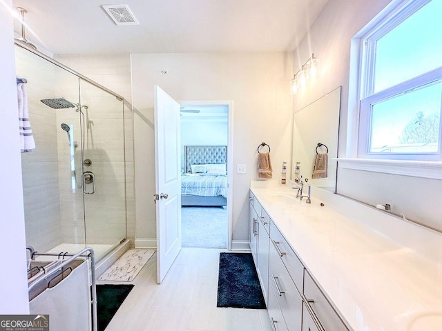 ensuite bathroom featuring vanity, a shower stall, visible vents, and connected bathroom