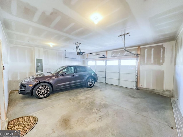 garage featuring electric panel and a garage door opener