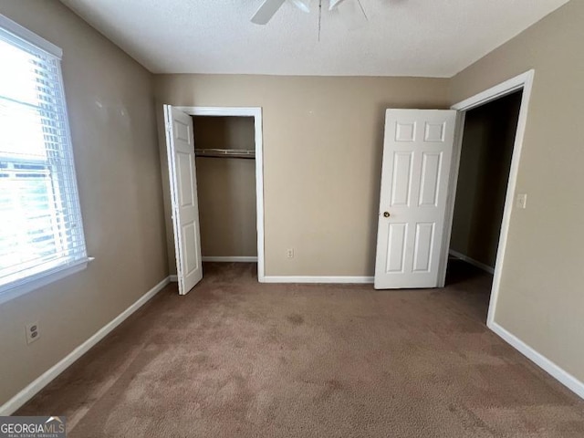 unfurnished bedroom featuring a closet, baseboards, and carpet