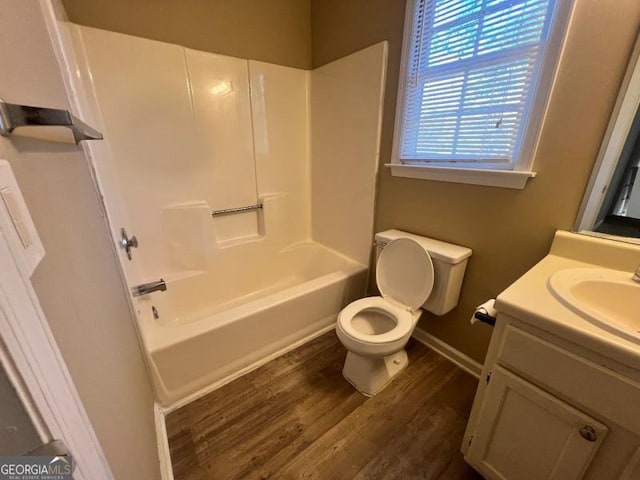 full bathroom featuring toilet, shower / washtub combination, wood finished floors, and vanity