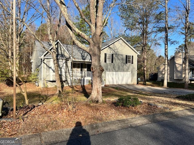 view of front facade with a porch, concrete driveway, and a garage