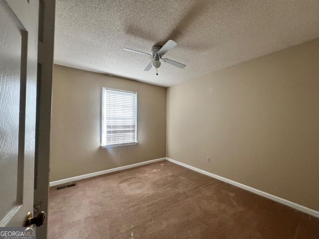 carpeted empty room featuring visible vents, baseboards, a textured ceiling, and ceiling fan