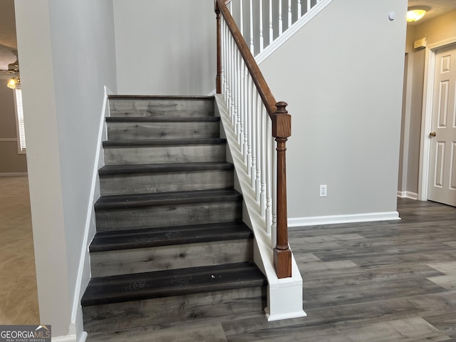 stairs with baseboards and wood finished floors