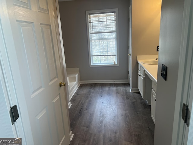 bathroom with vanity, baseboards, and wood finished floors