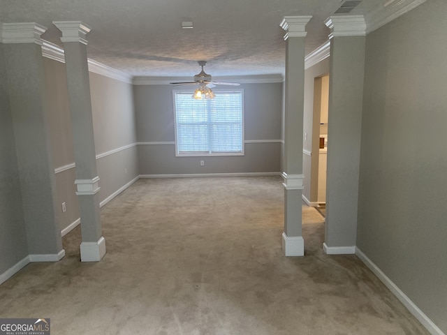 interior space featuring carpet floors, ceiling fan, ornamental molding, and ornate columns