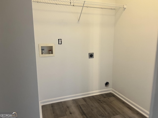 clothes washing area with baseboards, dark wood finished floors, laundry area, hookup for a washing machine, and hookup for an electric dryer