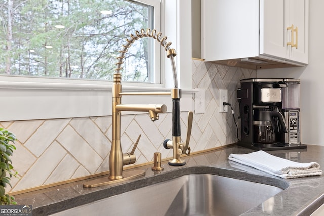 room details with decorative backsplash and white cabinets