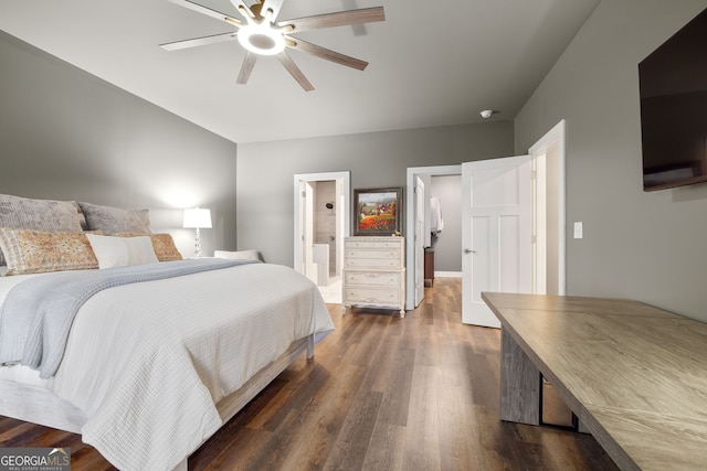 bedroom featuring ensuite bath, dark wood-type flooring, and a ceiling fan