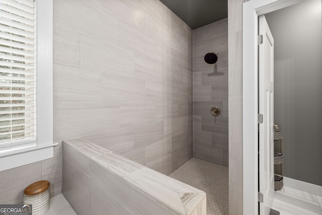 bathroom featuring a tile shower