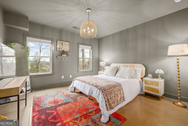 bedroom featuring visible vents, baseboards, a notable chandelier, and concrete floors