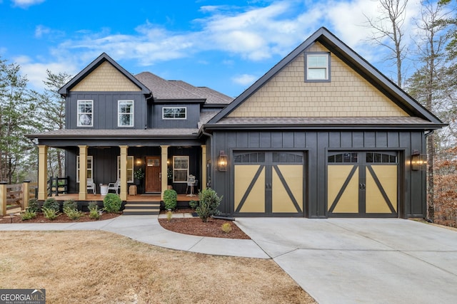 view of front of property featuring board and batten siding, a shingled roof, concrete driveway, covered porch, and an attached garage