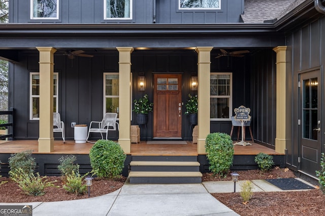 doorway to property with a porch, board and batten siding, and roof with shingles