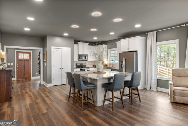 kitchen featuring dark wood finished floors, white cabinets, and appliances with stainless steel finishes