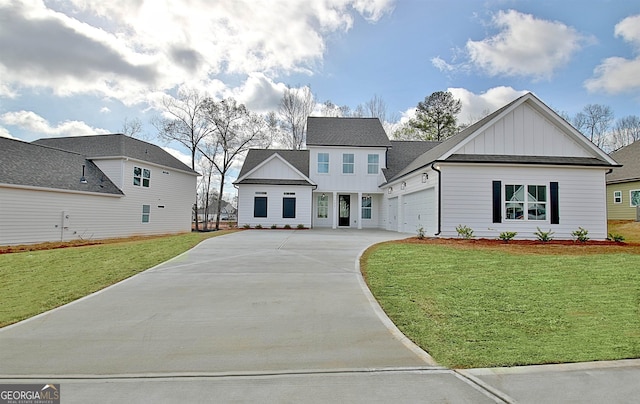 view of front of property with a front lawn, board and batten siding, concrete driveway, and an attached garage