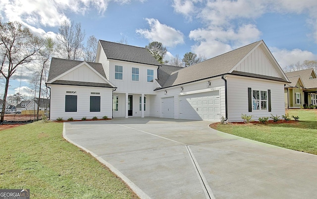 view of front of home featuring board and batten siding, a shingled roof, a front lawn, driveway, and an attached garage