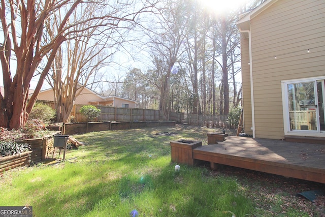 view of yard with a wooden deck and fence private yard