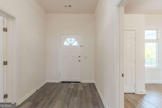 entrance foyer with visible vents, baseboards, and dark wood-style floors