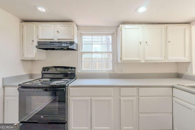 kitchen featuring under cabinet range hood, white cabinetry, black range with electric cooktop, and light countertops