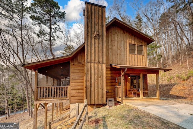 view of home's exterior with board and batten siding and a porch